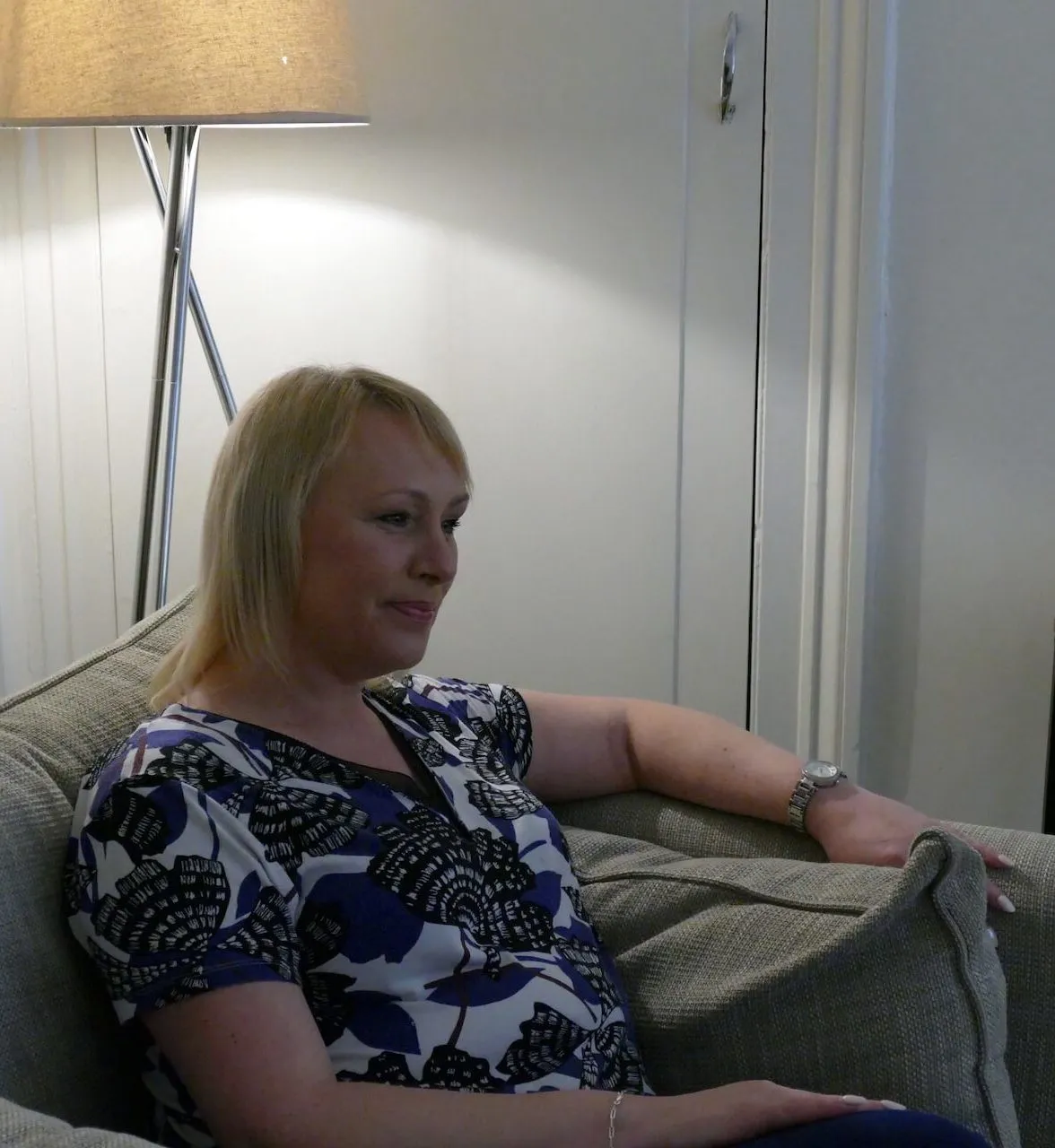 Close up photograph of Bev Herron sitting in a chair mid therapy / counselling session