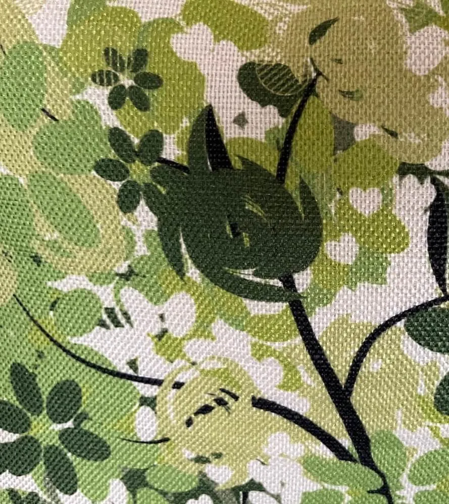 Close up of abstract printed fabric. Design represents plants and trees.