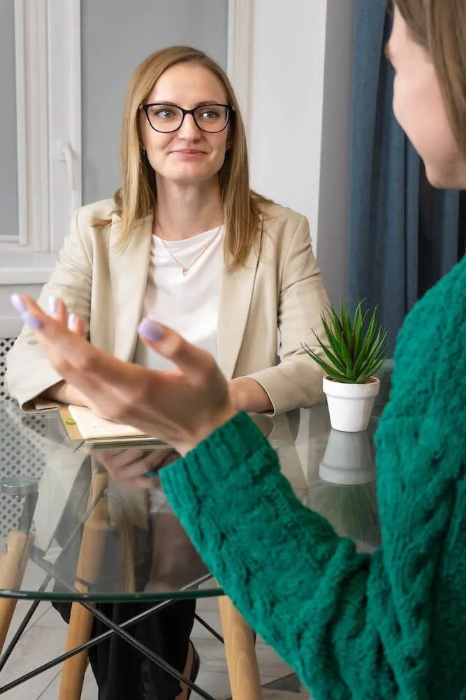 Close up photograph of a therapy session and the therapist taking notes