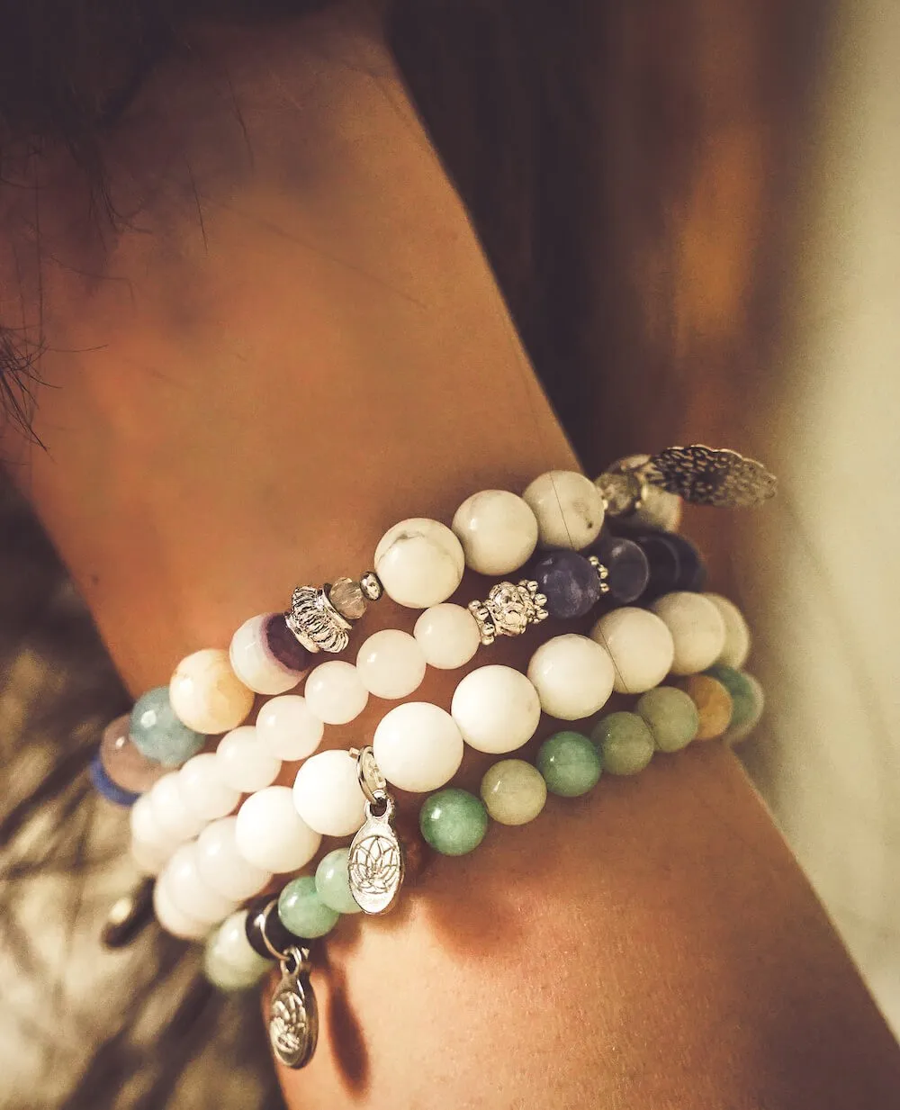 Woman's arm wearing beaded bracelets