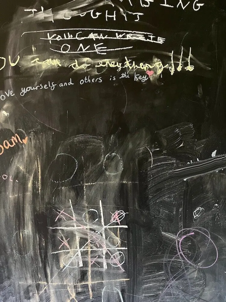 Chalk board with children's writing on it