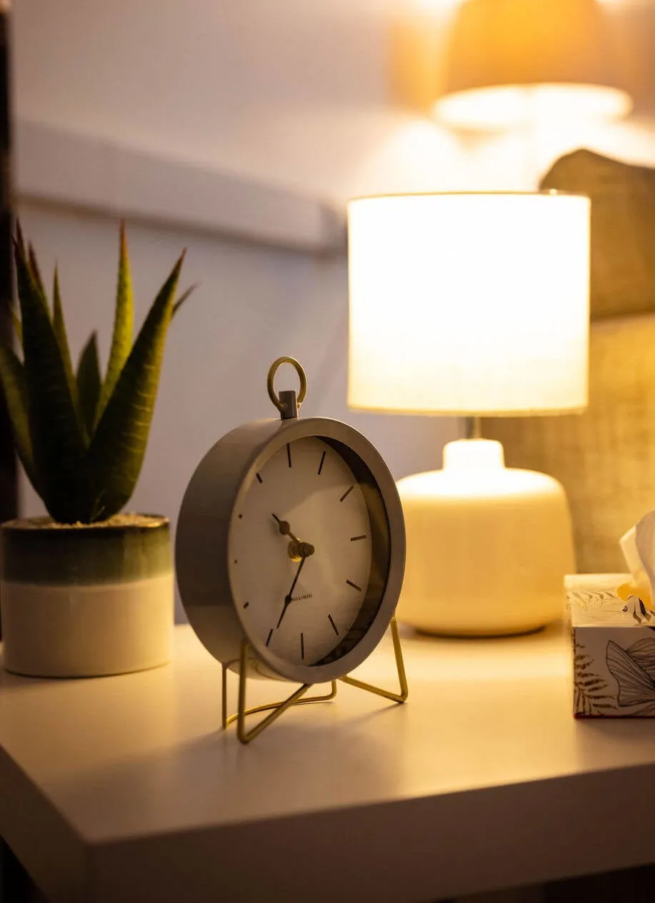 Photograph of a table showing a lamp, a clock, a plant and a box of tissues - photograph taken at Cudox, Grimsby