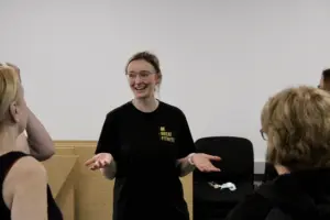 Outside in project leader shown laughing with open hands - Close Up