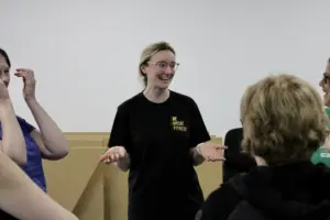Outside in project leader shown laughing with open hands