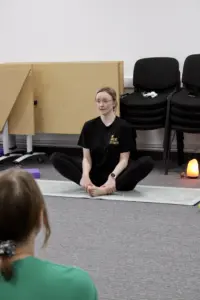 Trainer for the outside in project sat in a meditative position - cropped