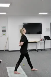 Trainer for the outside in project in a yoga pose