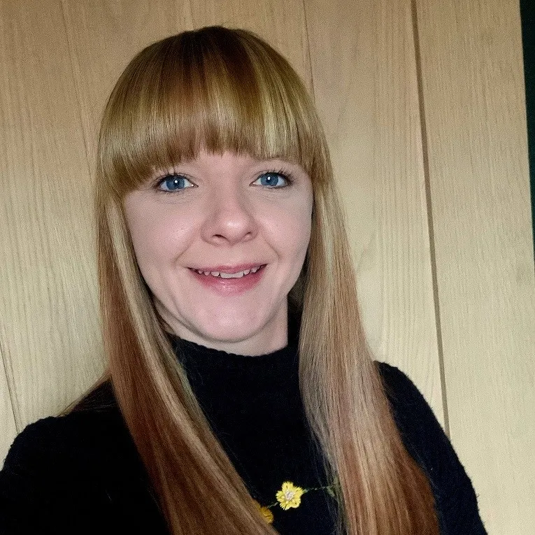 A photo of Cudox's Jess Brown smiling at the camera.